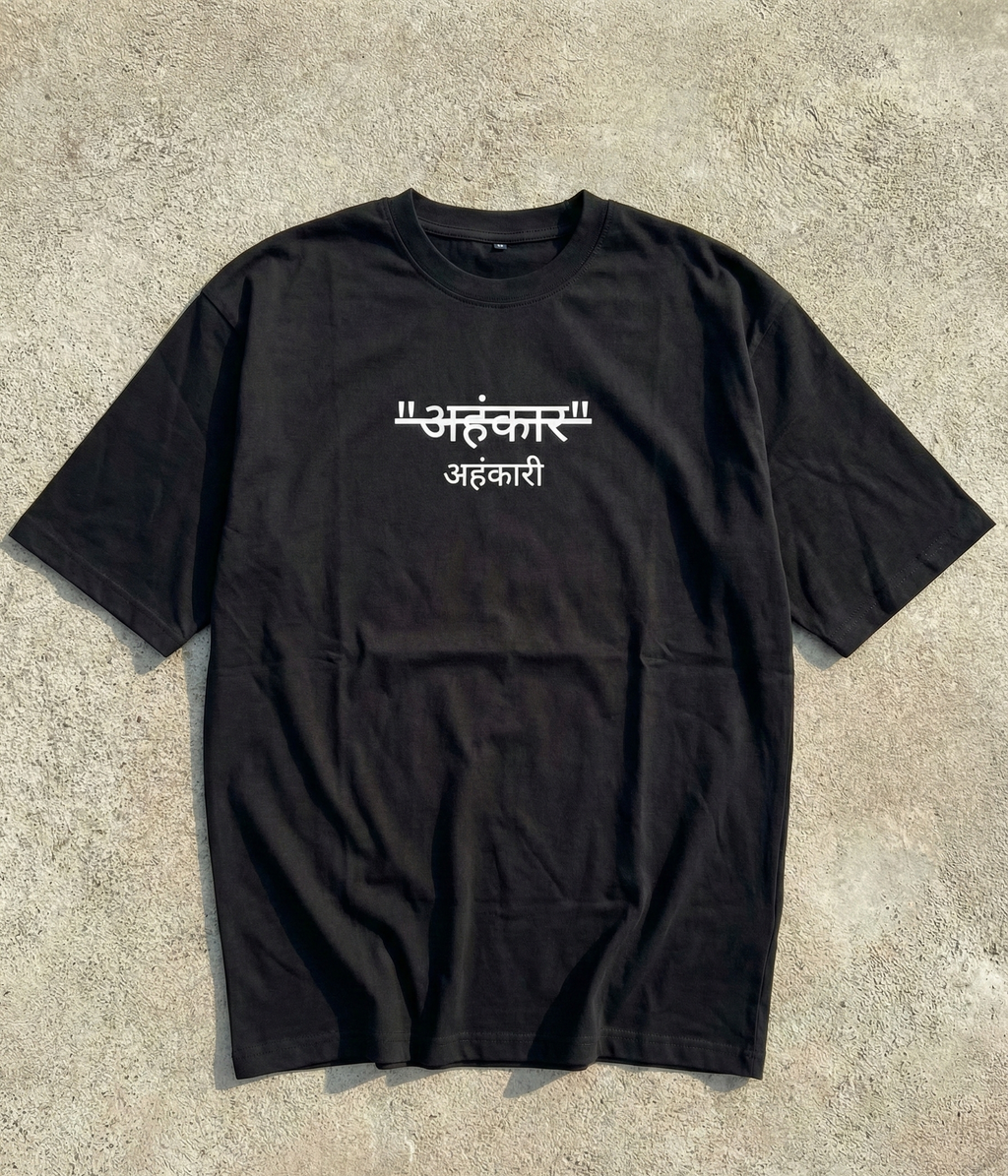 Black t-shirt with white text on a concrete surface